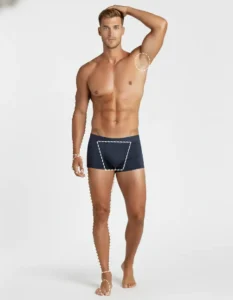 Man showing marked areas of male full body package laser hair removal treatment covering chest, back, legs, arms, and bikini line at professional clinic